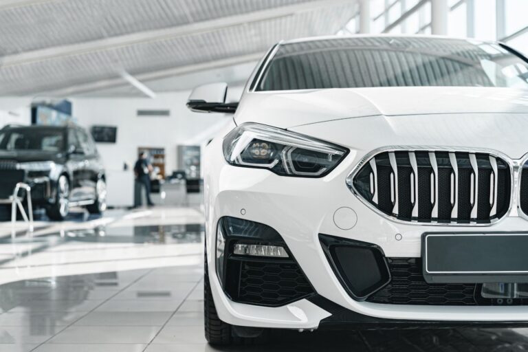 white-vehicle-interior-showroom-with-man-in-backgr-2026-01-09-06-33-23-utc