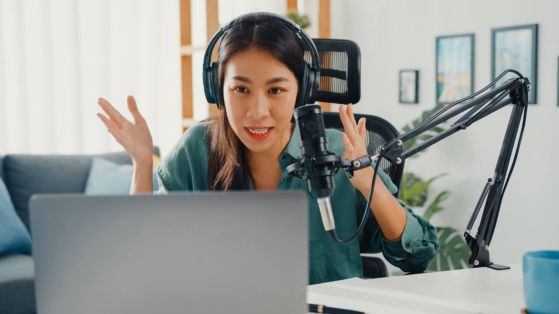 asia-girl-record-a-podcast-on-her-laptop-computer-2022-02-04-12-36-20-utc